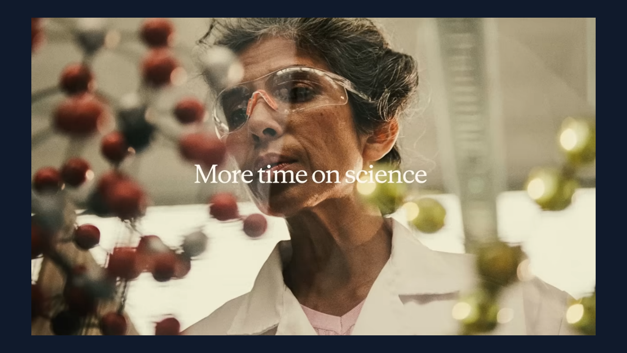 A researcher at work in the lab among molecular models and glassware